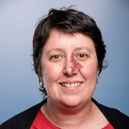 Headshot of a European woman with short dark hair